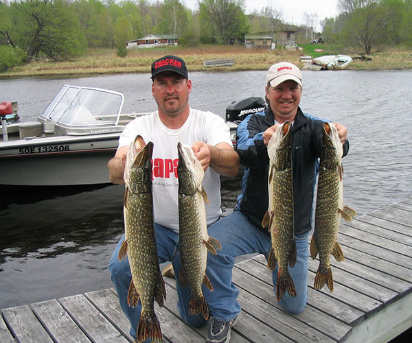 Key Marine Resort guest holding a fish on a boat.