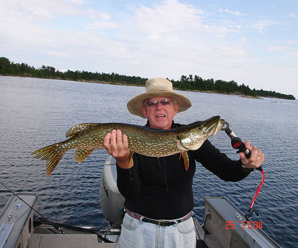 Key Marine Resort guest holding a fish on a boat.