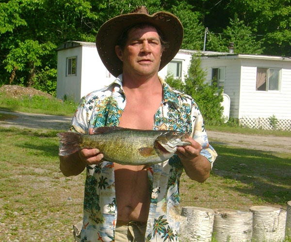 Key Marine Resort guest holding a fish on a boat.