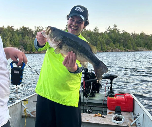 Key Marine Resort guest holding a fish on a boat.