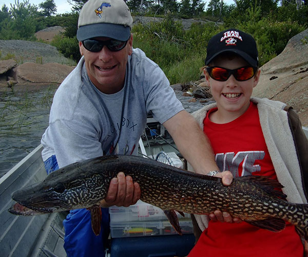 Key Marine Resort guest holding a fish on a boat.