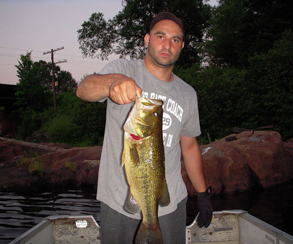 Key Marine Resort guest holding a fish on a boat.