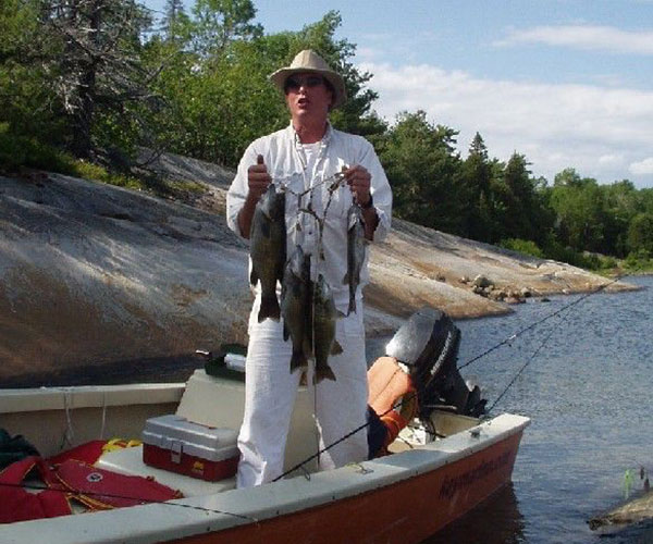 Key Marine Resort guest holding a fish on a boat.