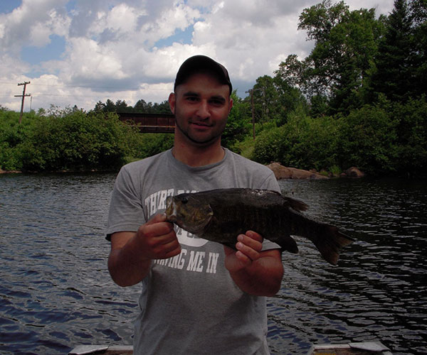 Key Marine Resort guest holding a fish on a boat.