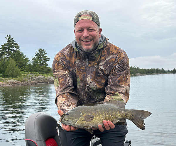 Key Marine Resort guest holding a fish on a boat.