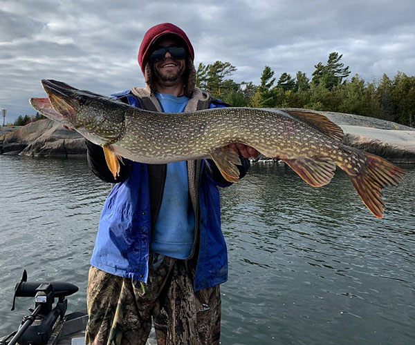Key Marine Resort guest holding a fish on a boat.