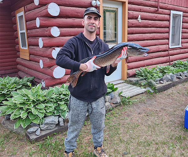 Key Marine Resort guest holding a fish on a boat.